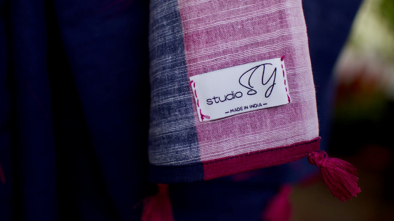 Linen Cotton handcrafted, naturally dyed saree in blue colour with deep pink border and dandelion motifs.