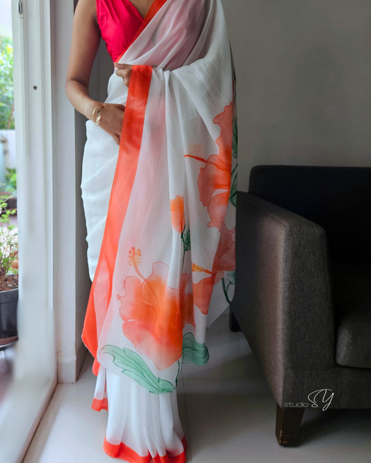 Snow white organza saree with red hand painted and printed floral art