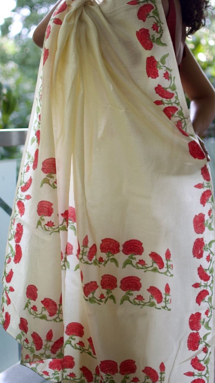 Handwoven cream chanderi saree, hand block printed with traditional floral motifs in rich red and green natural dyes.