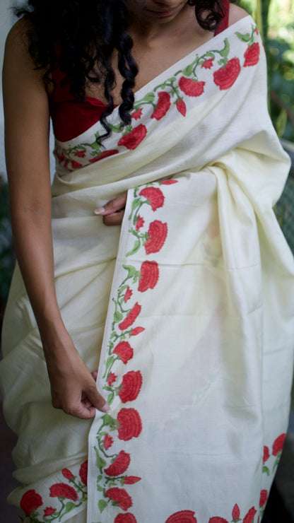Handwoven cream chanderi saree, hand block printed with traditional floral motifs in rich red and green natural dyes.