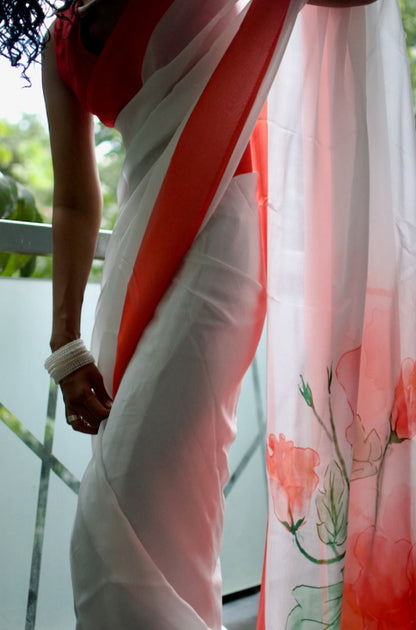 Snow white organza saree with red hand painted and printed floral art