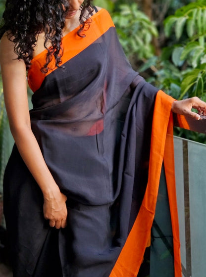 Deep black organza saree with fiery orange hand painted and printed floral art