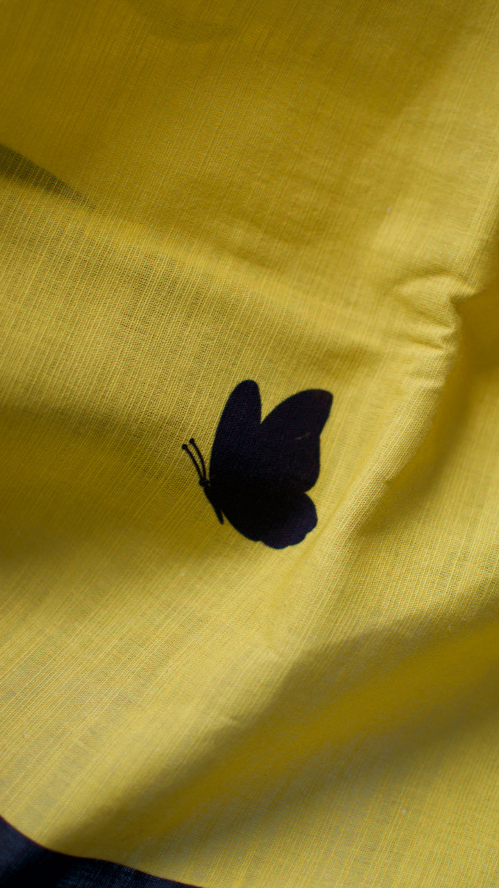 Linen Cotton handcrafted, naturally dyed saree in yellow colour with black border and butterfly motifs.