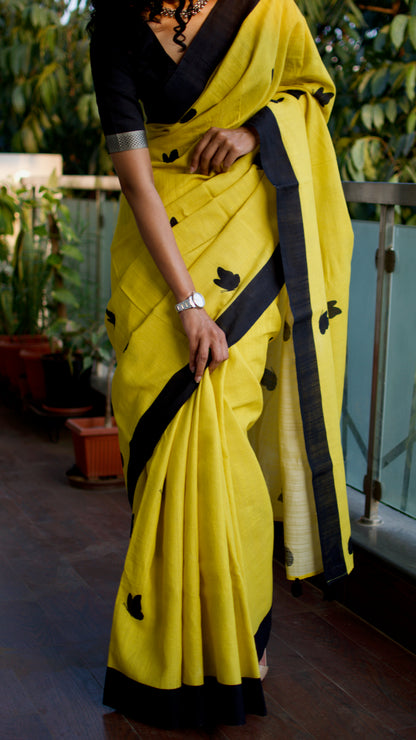 Linen Cotton handcrafted, naturally dyed saree in yellow colour with black border and butterfly motifs.