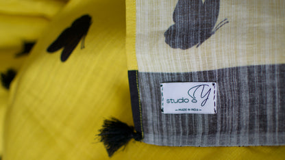 Linen Cotton handcrafted, naturally dyed saree in yellow colour with black border and butterfly motifs.