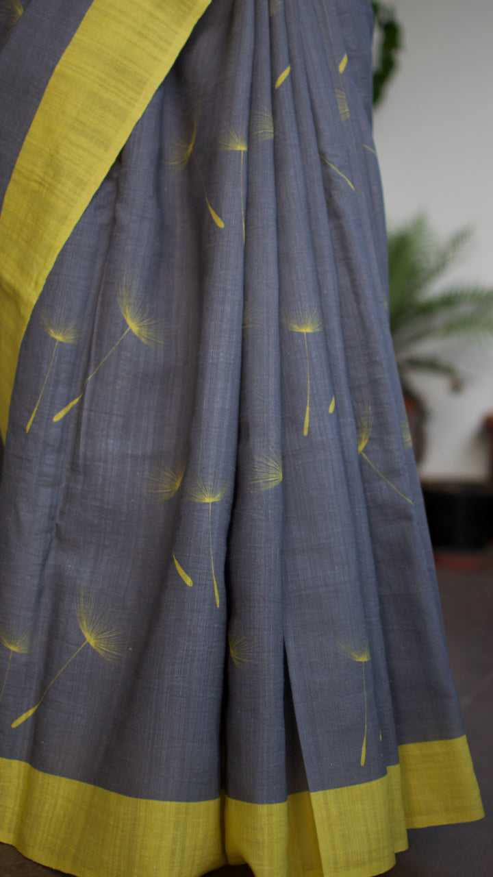 Linen Cotton handcrafted, naturally dyed saree in grey colour with yellow border and dandelion motifs.