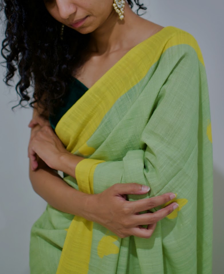 Linen handcrafted handloom saree, dyed with green natural dye and all over yellow butterfly motif print
