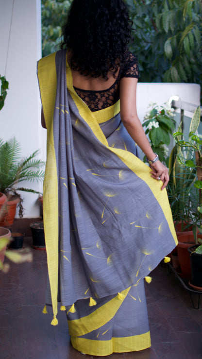 Linen Cotton handcrafted, naturally dyed saree in grey colour with yellow border and dandelion motifs.