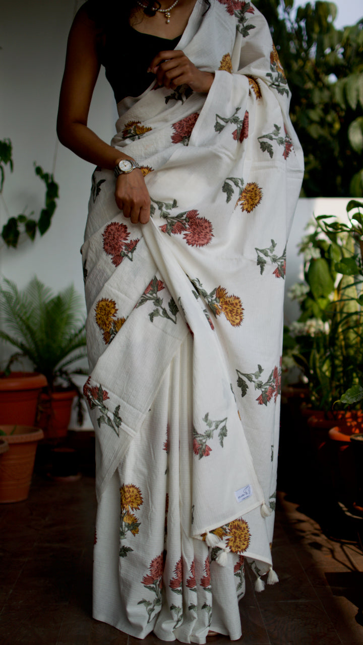 Cotton handcrafted, naturally dyed saree in white colour with handblocked floral motifs and all over kantha weave in white thread.