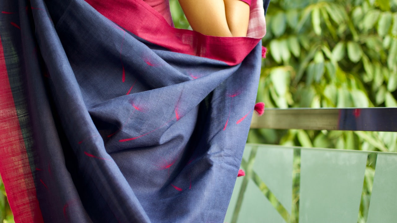 Linen Cotton handcrafted, naturally dyed saree in blue colour with deep pink border and dandelion motifs.