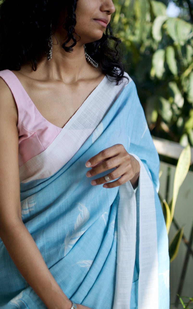Linen Cotton handcrafted, naturally dyed saree in blue colour with white border and feather motifs.