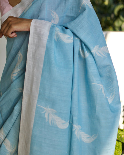 Linen Cotton handcrafted, naturally dyed saree in blue colour with white border and feather motifs.