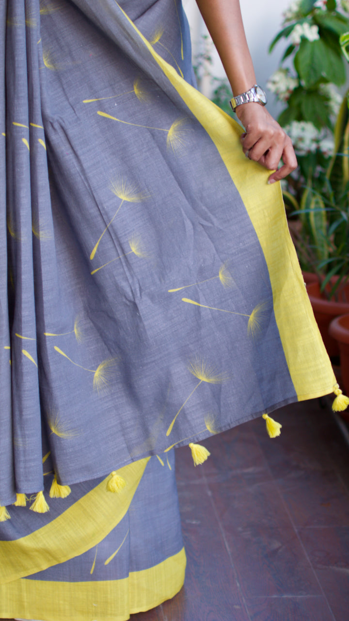 Linen Cotton handcrafted, naturally dyed saree in grey colour with yellow border and dandelion motifs.